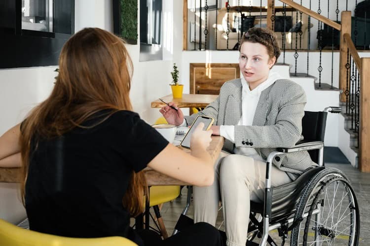 Women in a wheel-chair interviews a job seeker