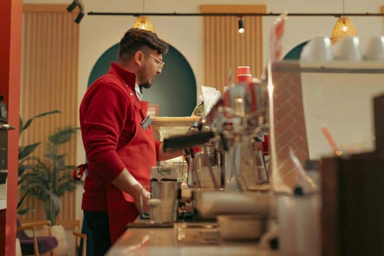 Barista makes coffee in a cafe