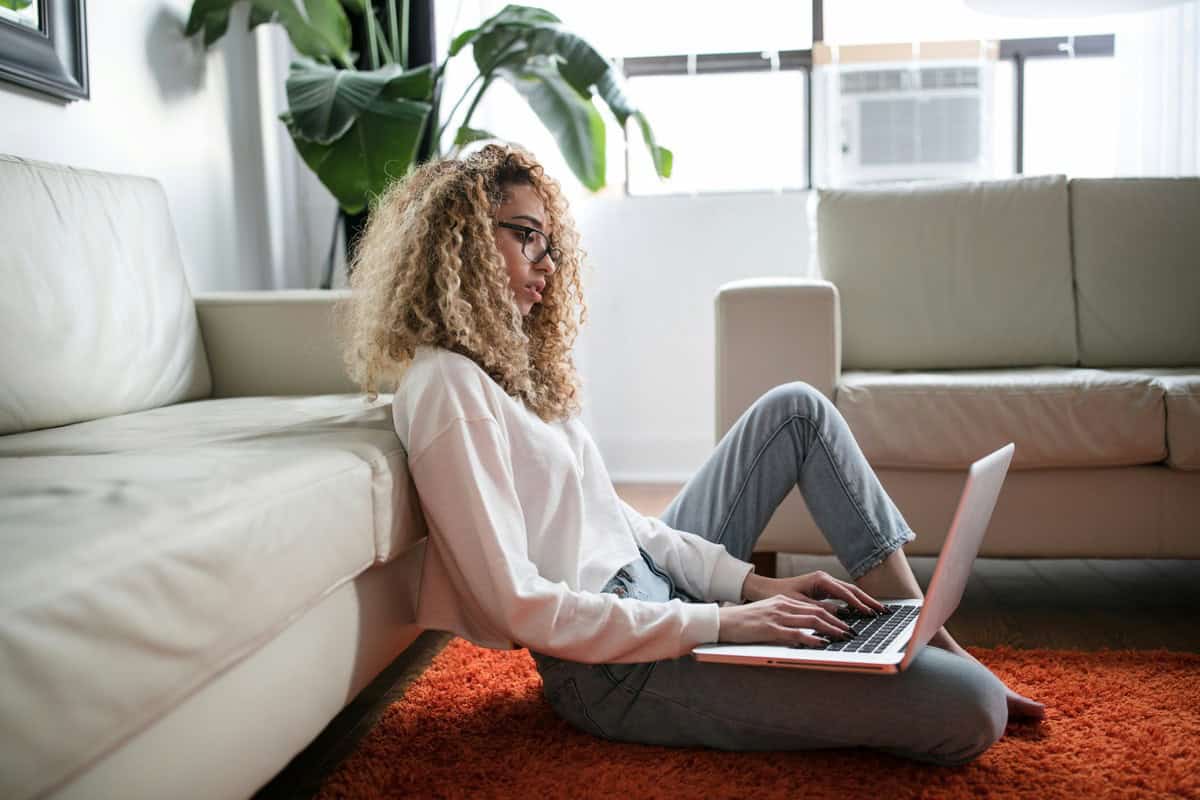 Girl writing here 2-week notice letter on the computer